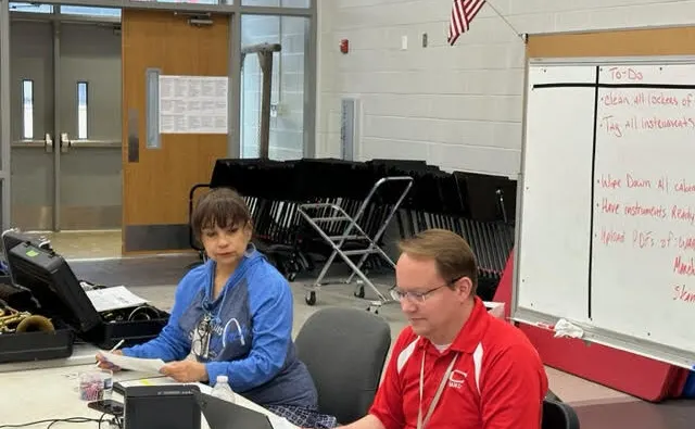 Dr. Aaron Hawley conducts his end of year music instrument inspection with CutTime.