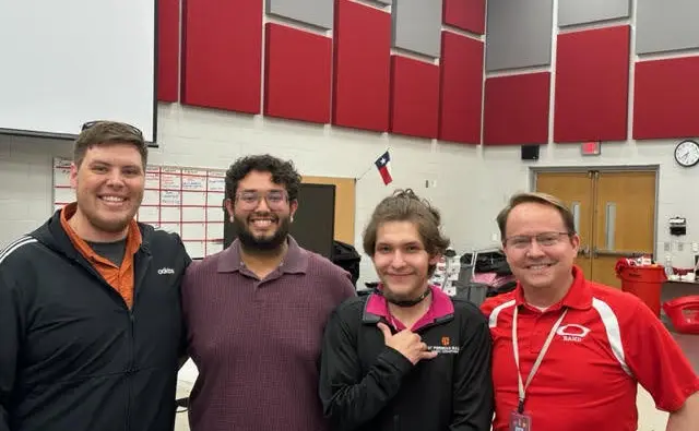 Dr. Aaron Hawley celebrates with his volunteer team a successful end of year music instrument inspection with CutTime.